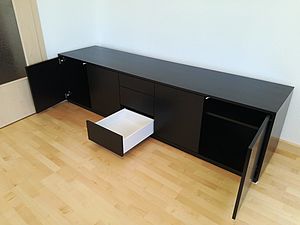 Sideboard mit Türen und Schubladen in schwarzem Lack mit geöffneter Schublade